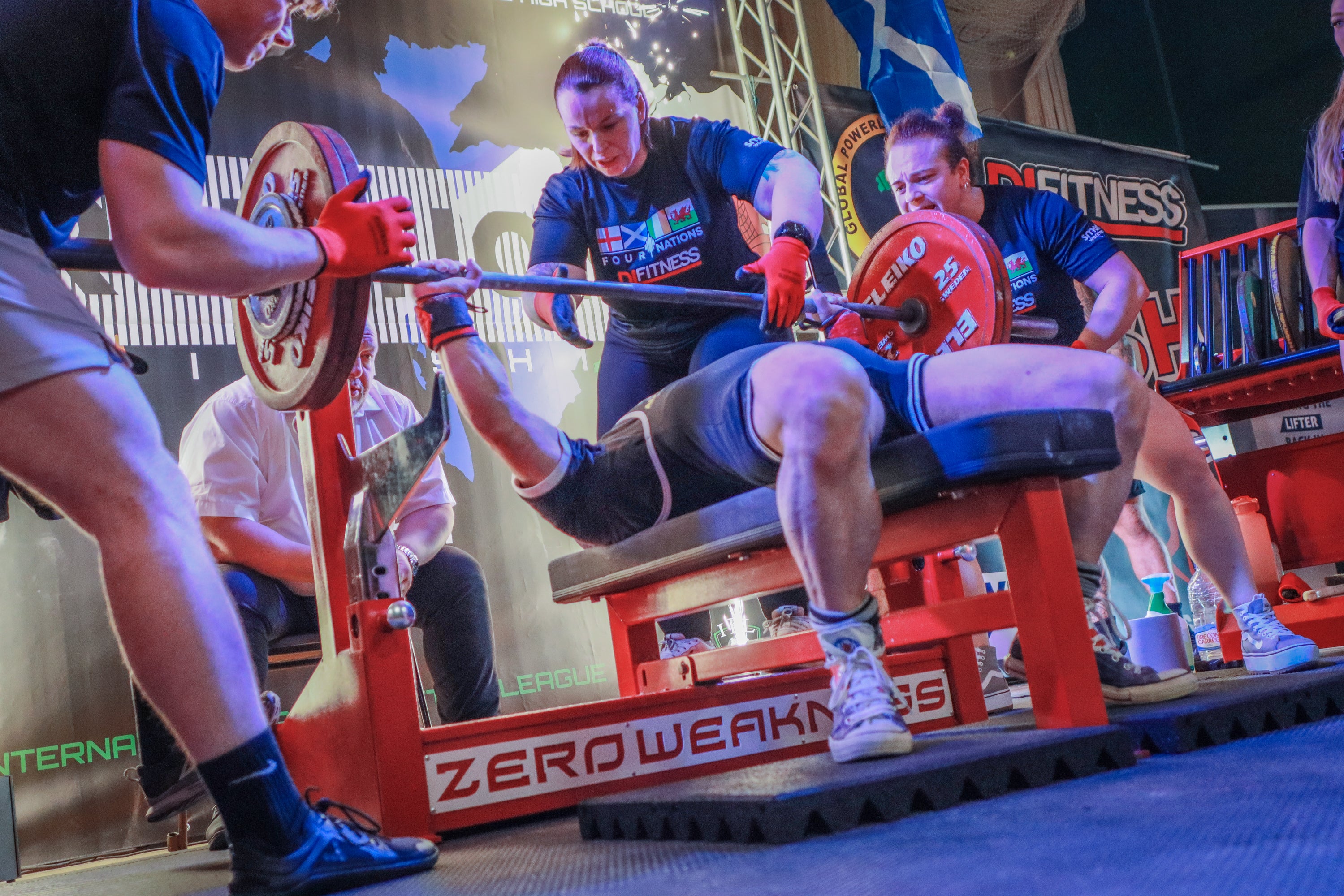 People participating in a fitness competition on a branded exercise machine.